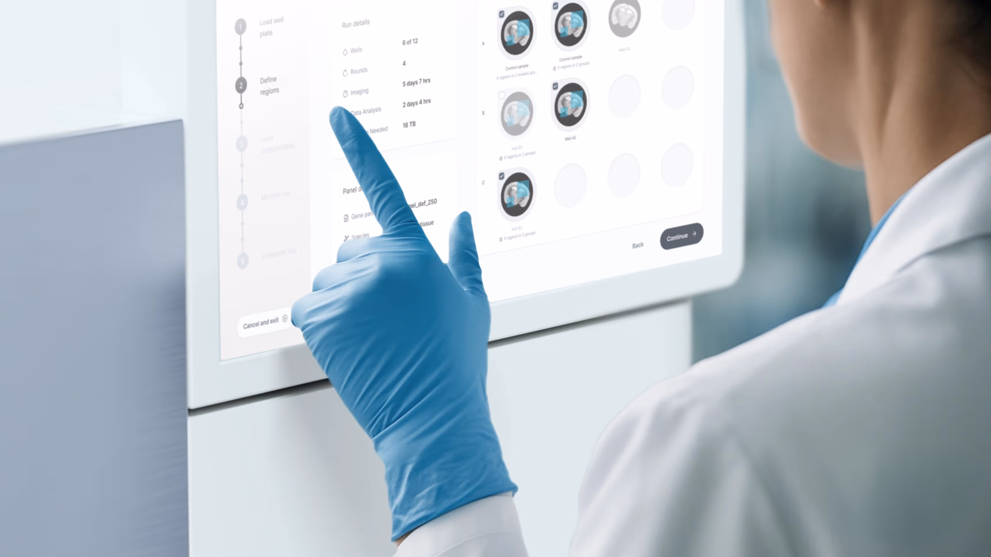 Lab technician in gloves reviewing the Monitor Run screen on the Pyxa instrument interface, showing well status grid and experiment progress.