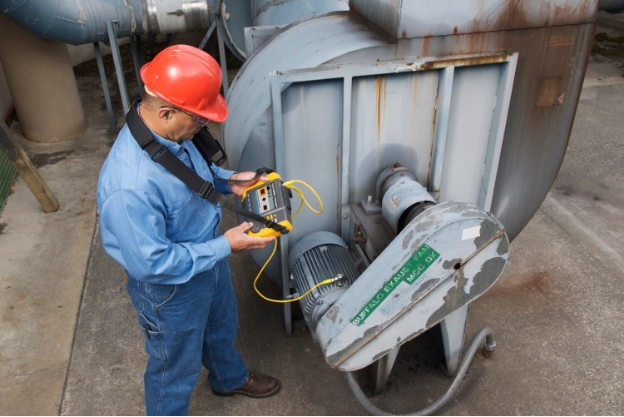 A person wearing a hard hat and holding a yellow deviceAI-generated content may be incorrect.