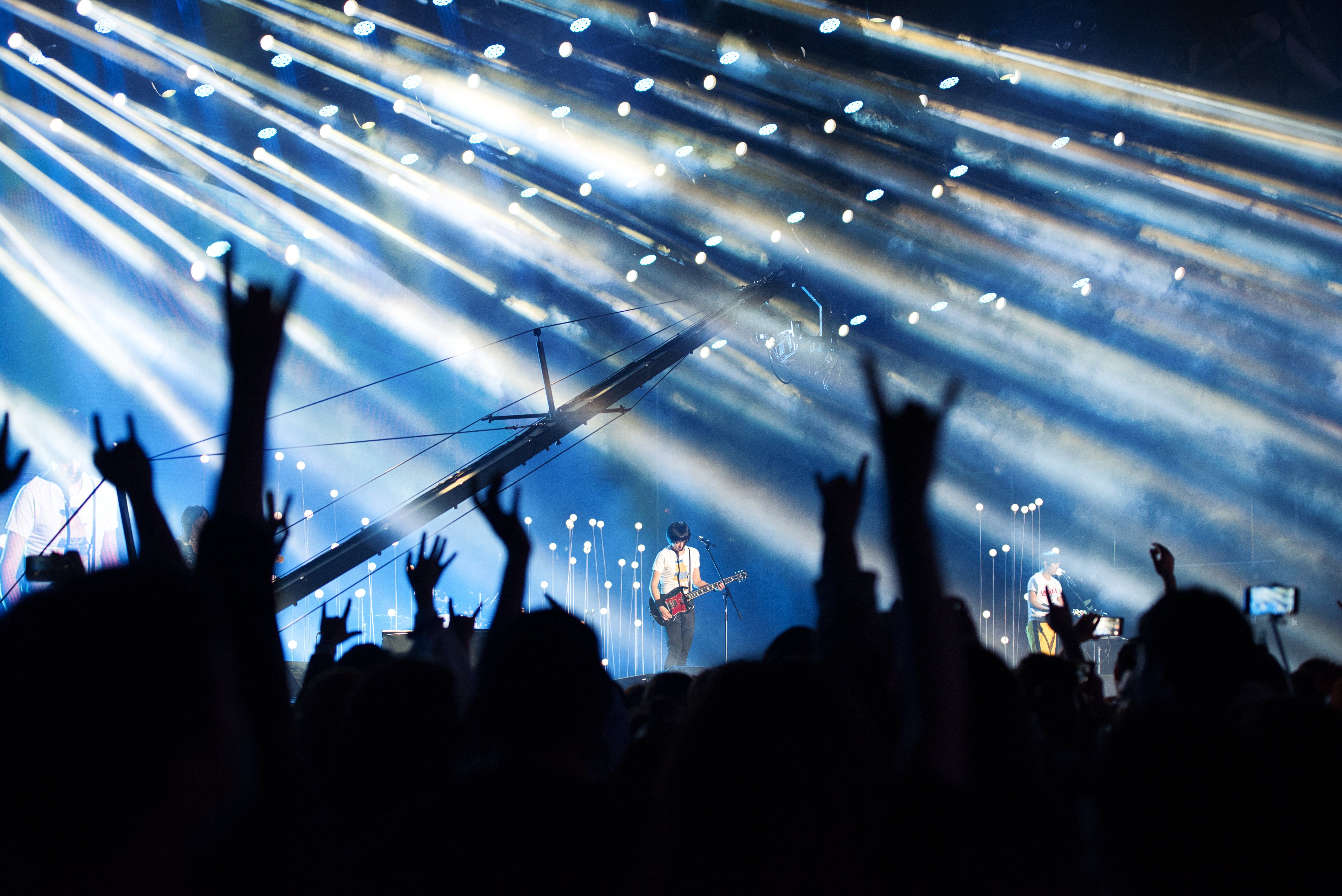 Invested Fan showing a SongVest access pass at a concert entrance