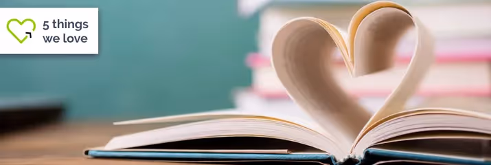 Book opened with pages making a heart shape