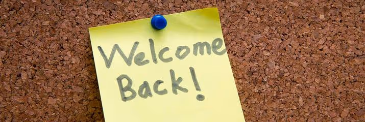 Post-it note with welcome back written on it