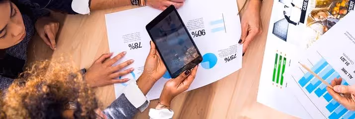 Woman holding iPad with a graph on the screen