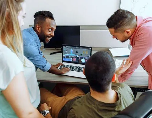 Group of students surrounding a laptop