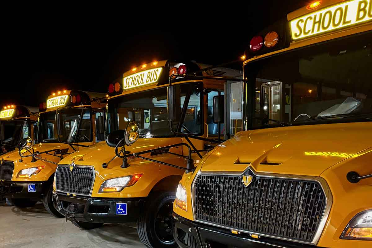 New school buses in parking lot