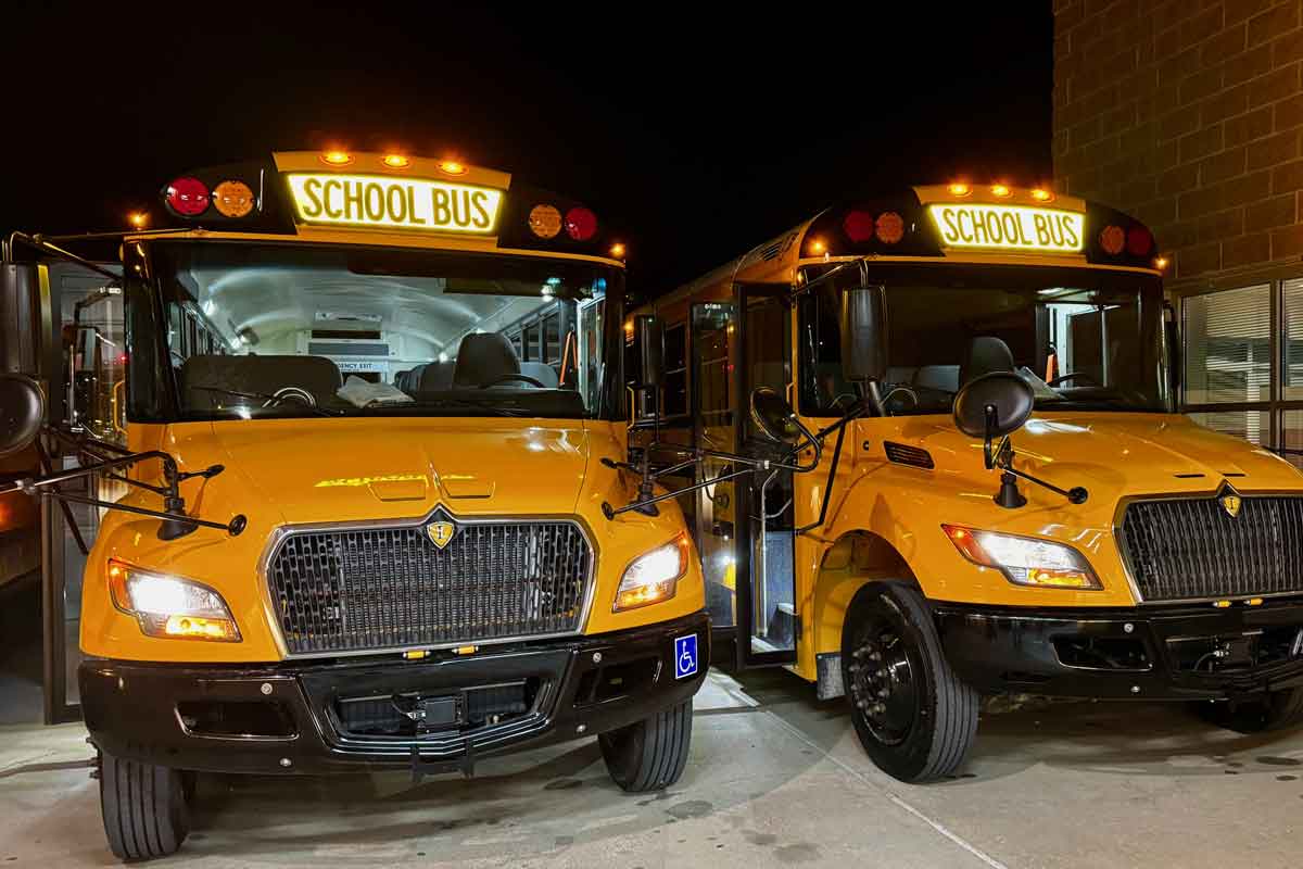 New school buses in parking lot