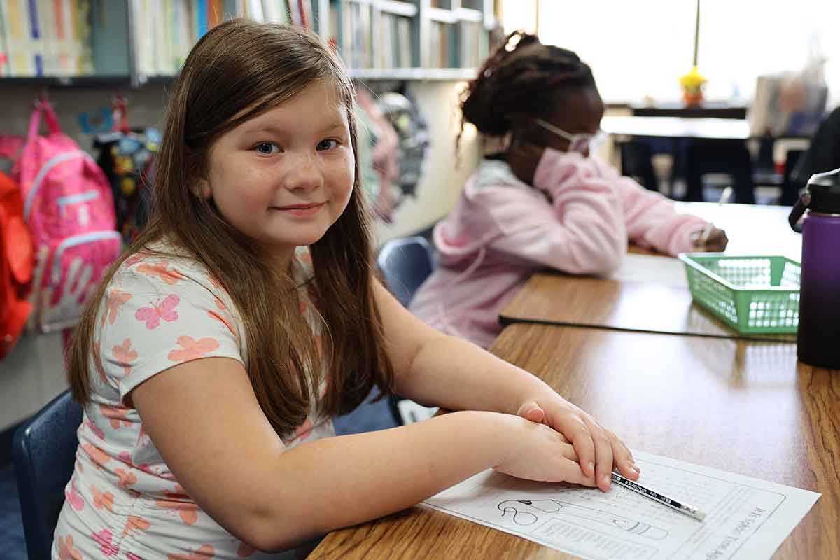 Student sitting at desk in school.