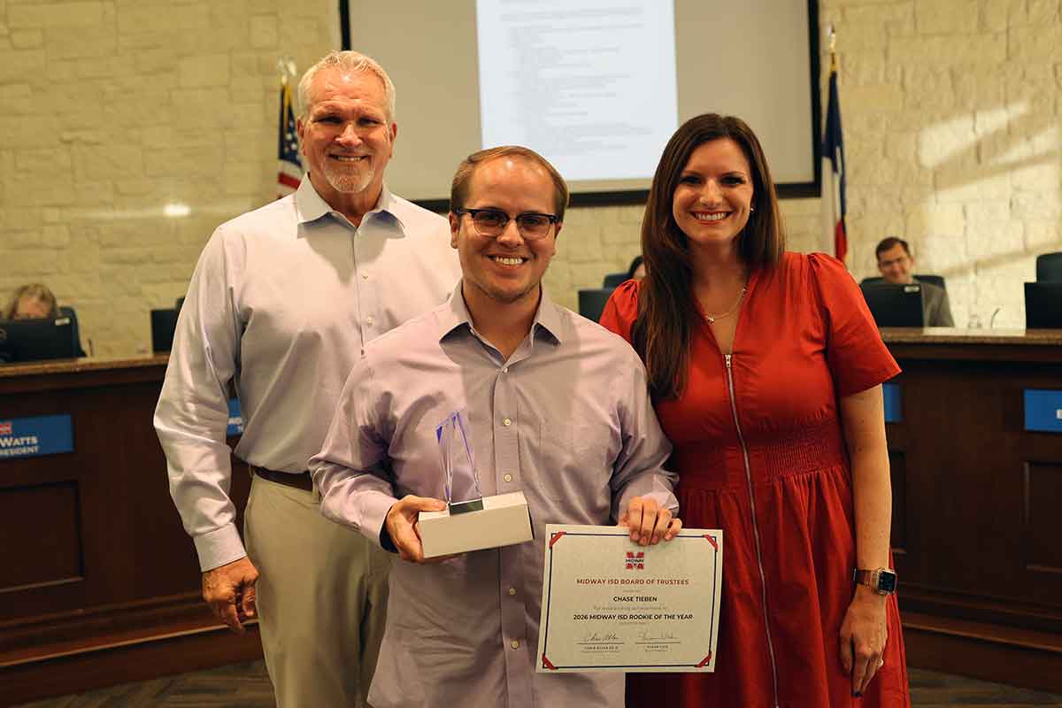 Teacher receiving award at school board meeting