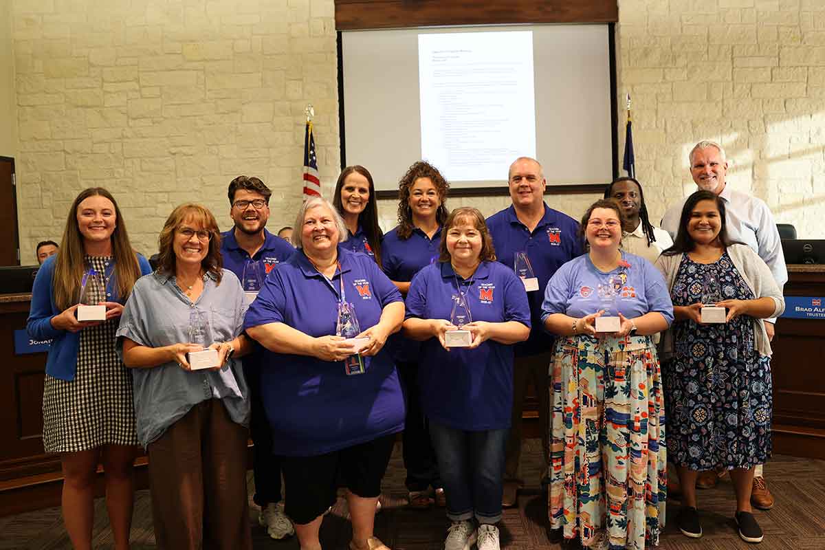 Teachers receiving awards at school board meeting