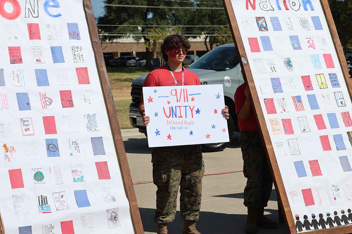 Student holds sign at Unity Day ceremony