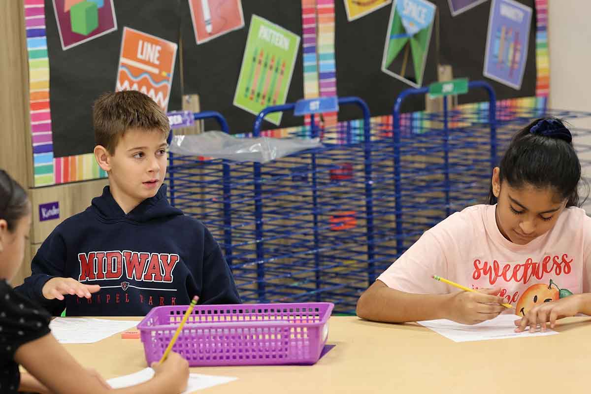 Students in class woking at a desk
