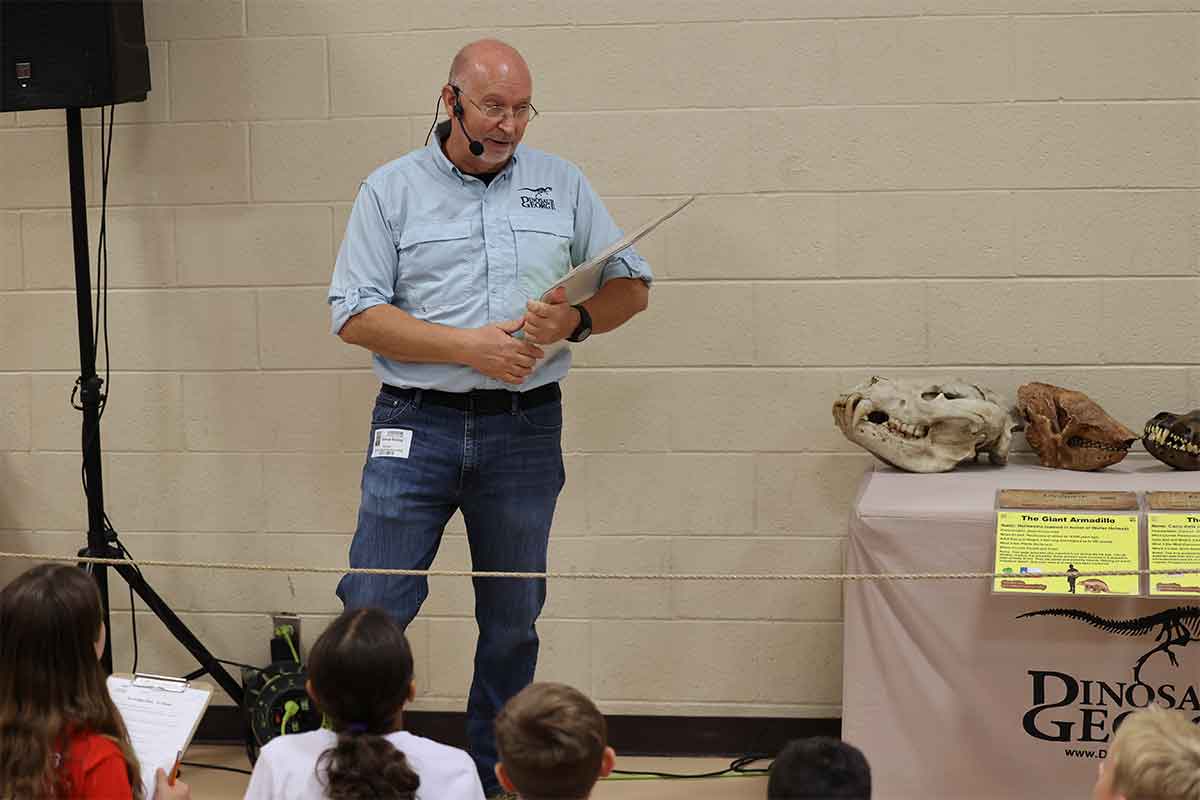 Dinosaur George Traveling Museum founder talking with students.