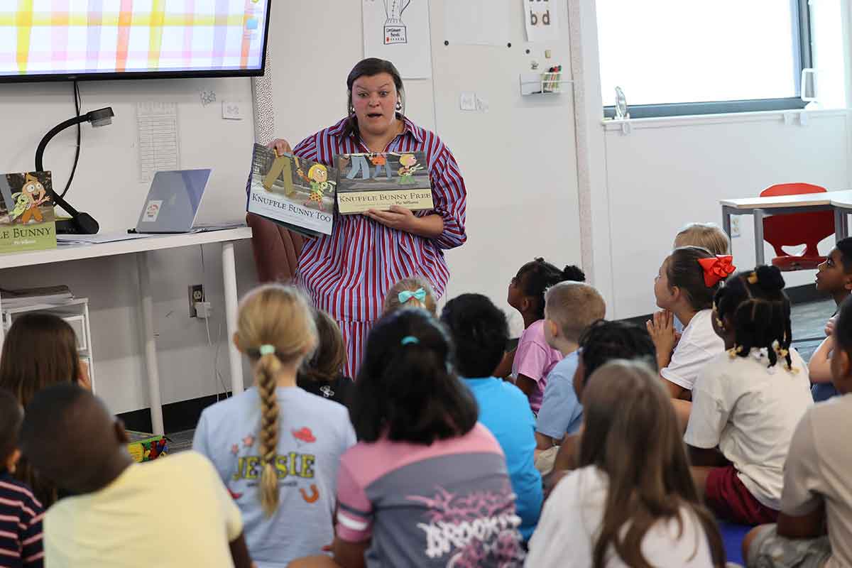 Midway teacher reading with students.