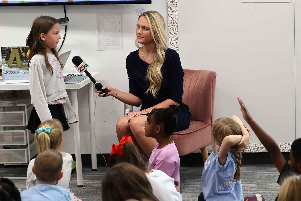 Channel 25 reporter Alexa Conroy talking with students.