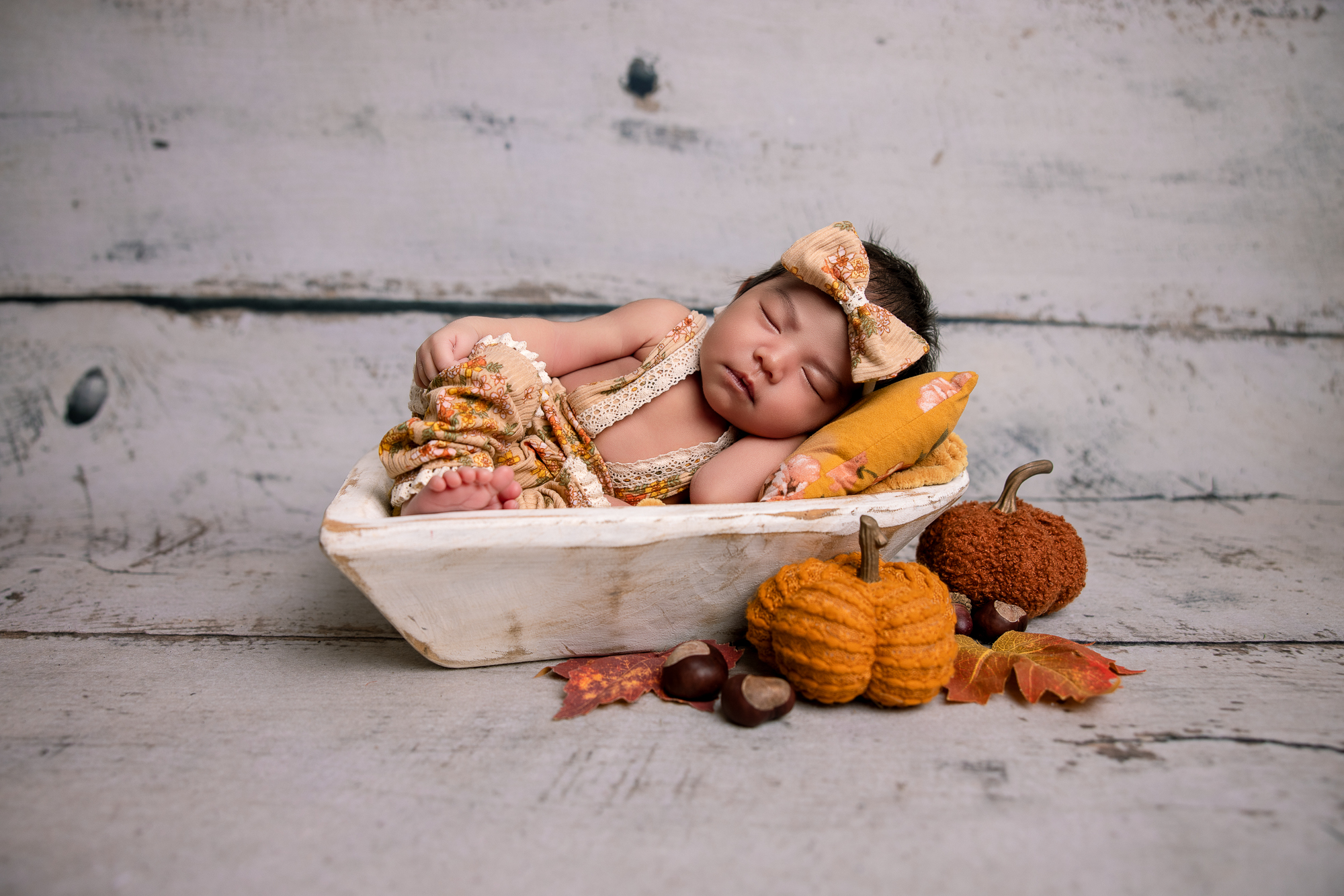 Sleeping newborn gets photographed by Katja Jones Photography for a professional newborn photoshoot.