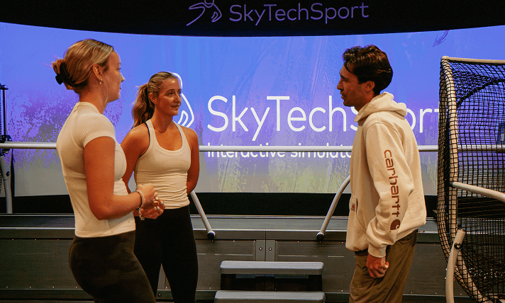 Members chatting beside the ski simulator at Home Mountain