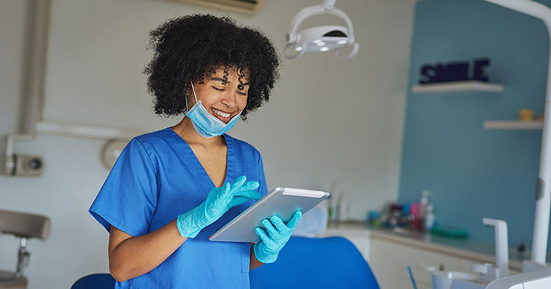 dentist uses tablet in treatment room