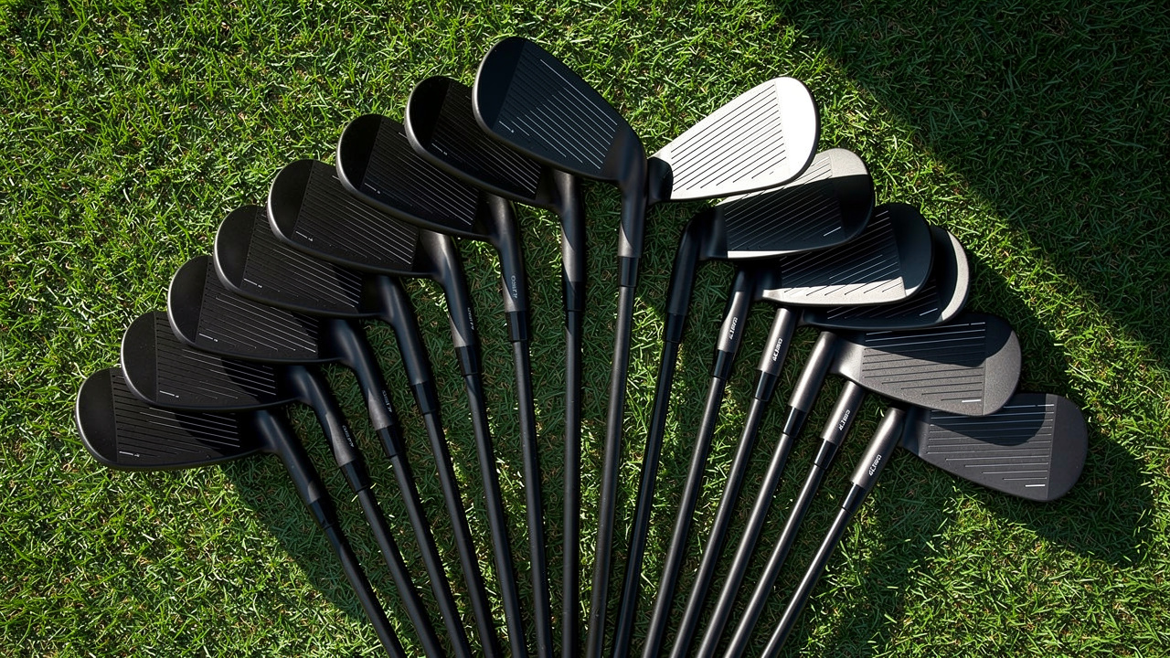 Complete set of matching iron clubs arranged on grass