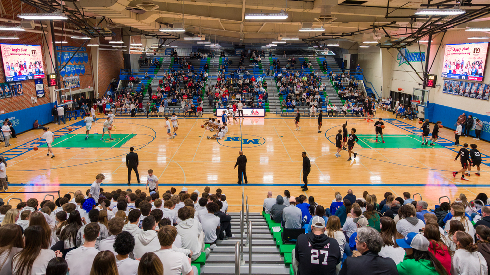 Millard North High School gym featuring two LED video scoreboards and LED scorer's table