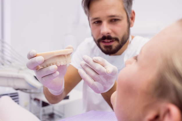 A Dental Expert Explaining How Fixed Implant Bridges Work to Bridge the Dental Gaps