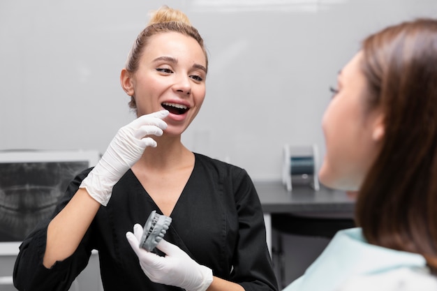 A Dentist Demonstrating How Implants Keep Your Surrounding Teeth from Shifting