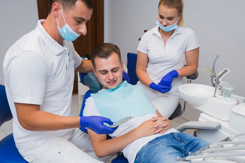 A dental hygienist performing dental cleaning at her dental hygiene clinic.