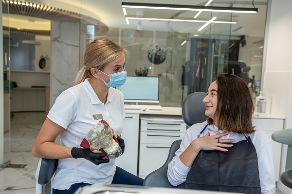 A family dentist near you explains the dental cleaning procedure at a modern dental office near Mercer Island, WA.