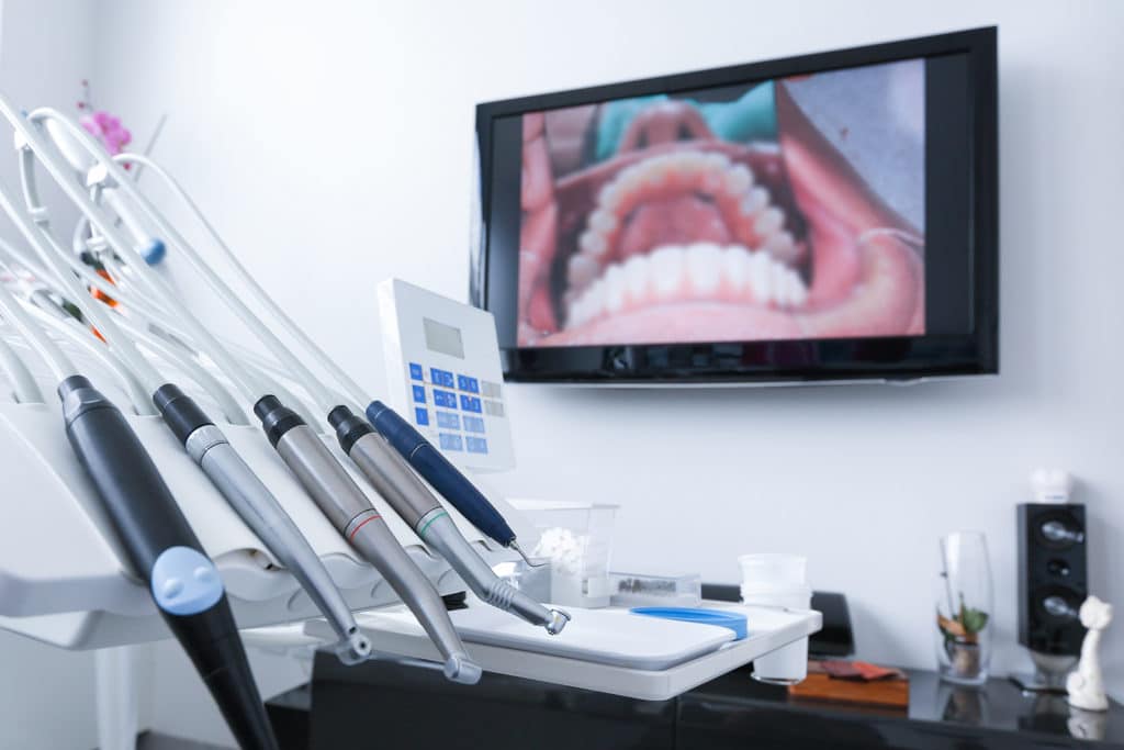 Endodontist performing a root canal procedure.