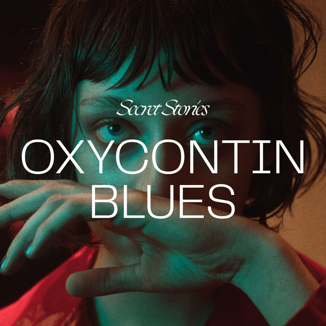 close up of face of pretty girl with short black hair wiping her nose with the back of her hand, there is a white text overlay saying secret stories in a script font and oxycontin blues in a sans serif font