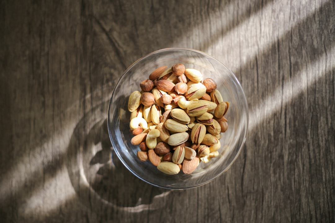 brown peanuts in clear glass bowl
