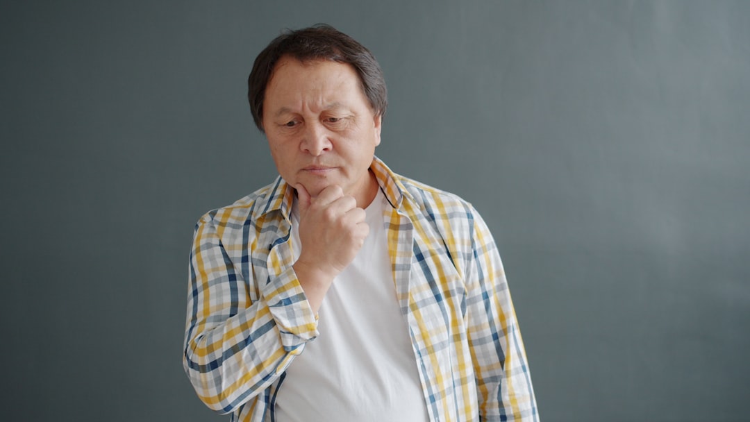 Man touching his chin with a thoughtful expression.