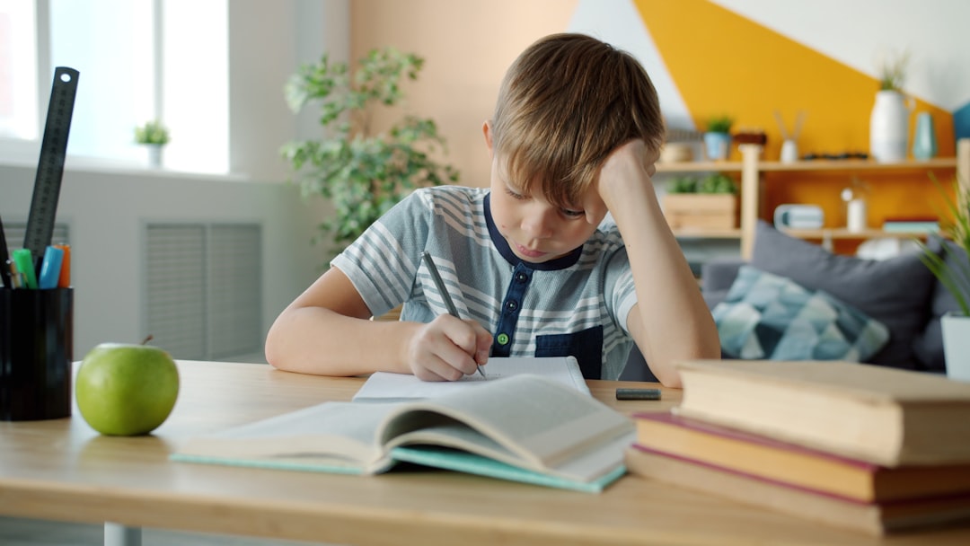 child doing homework at desk