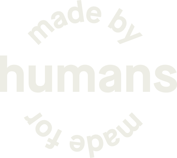 Cream-colored typographic logo on a muted green background reading “made by humans made for,” with curved text above and below the large word “humans.”
