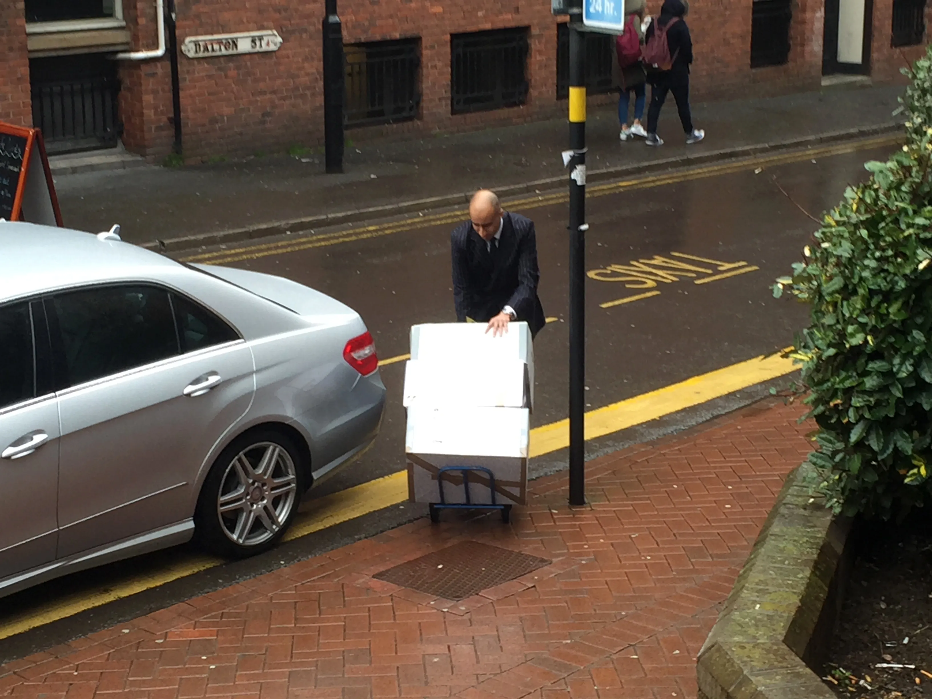 Court staff pushing 3 large boxes of paper documents required for criminal proceedings.