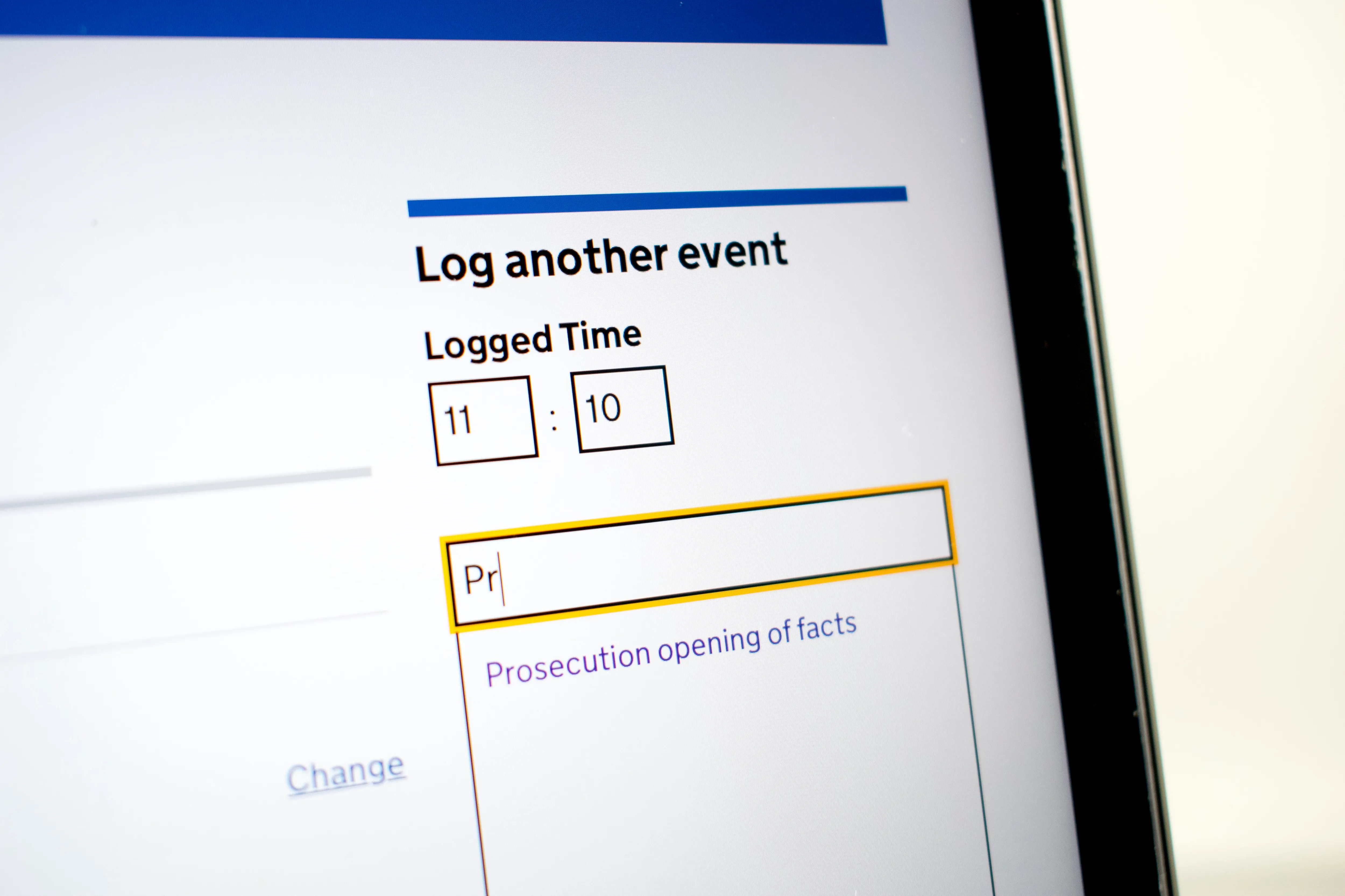 Close-up of website pattern to 'Log another event' showing time fields set to 11:10 and a text box where 'Pr' is typed, with a suggestion 'Prosecution opening of facts' below.