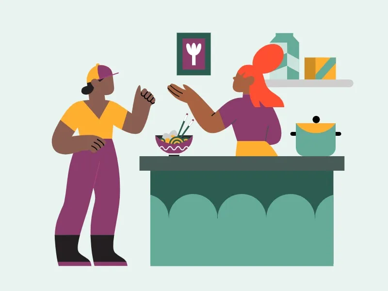 two people in a kitchen talking