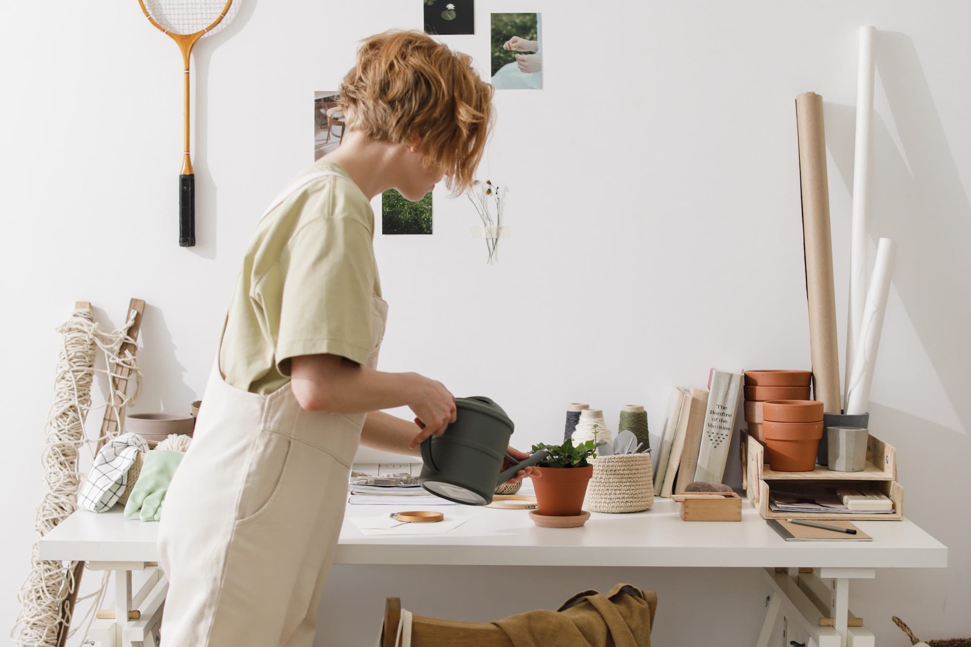 woman watering a potted plant