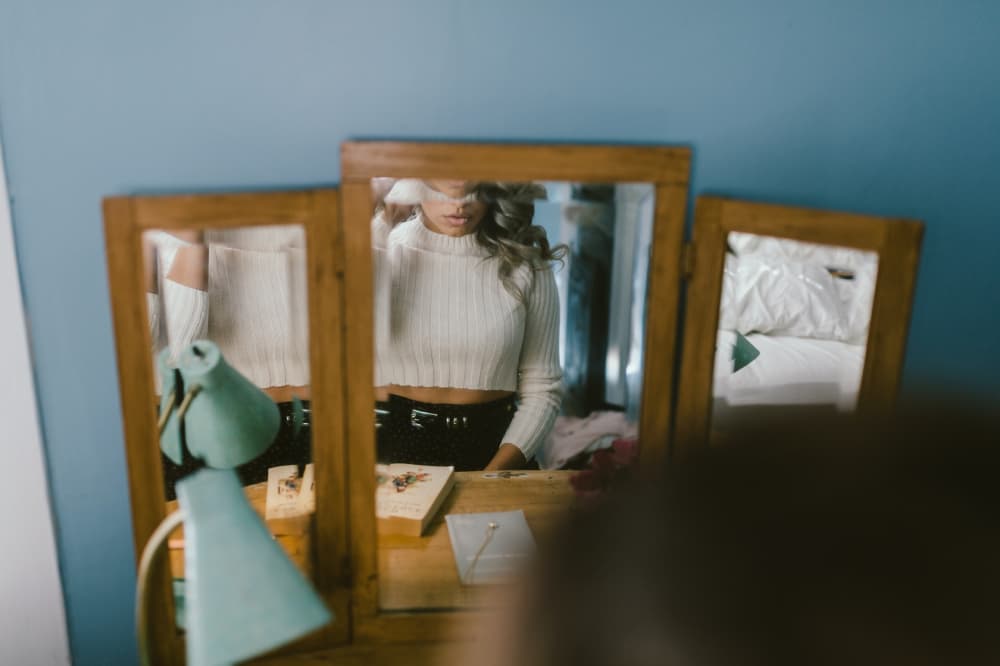 Woman looking into a mirror