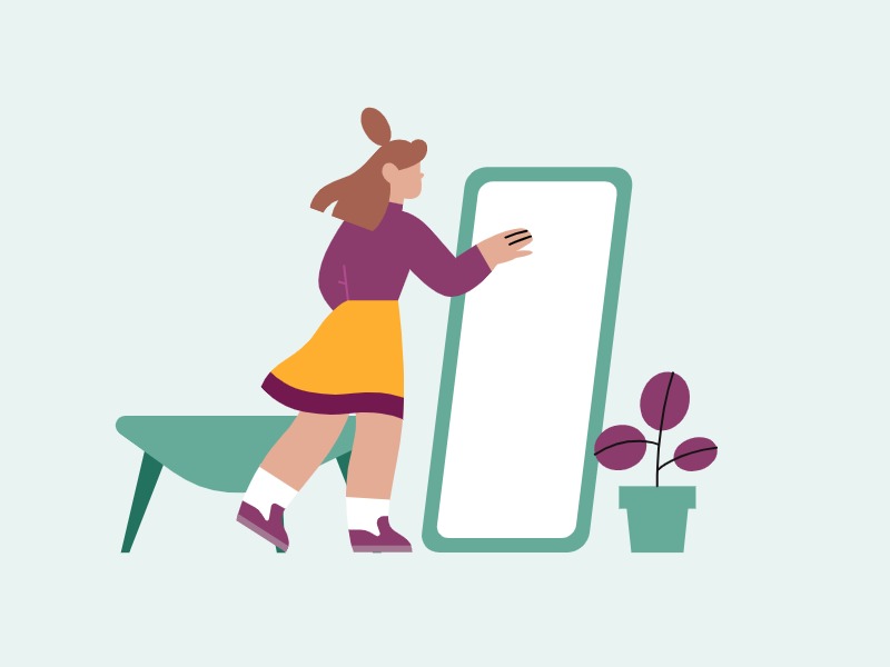 woman looking at self in a mirror