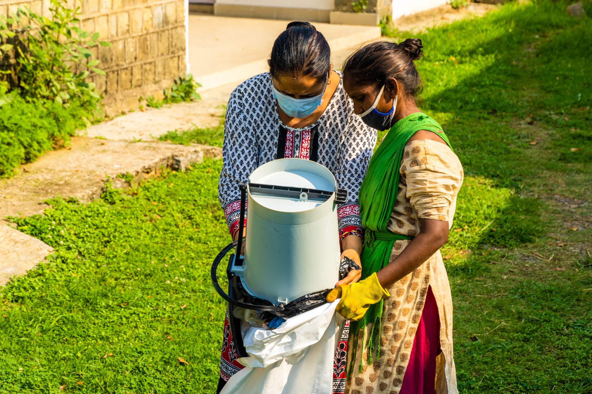 a woman wearing a face mask and holding a machine