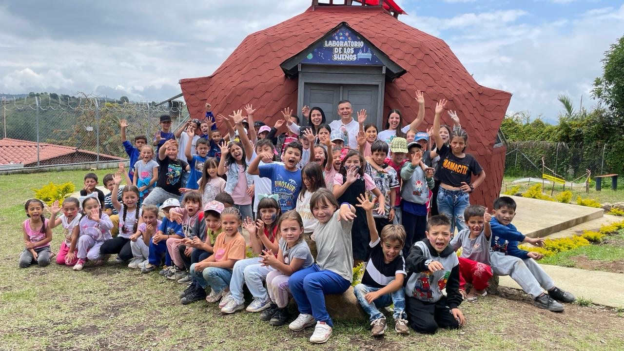 a group of children and a man posing for a photo