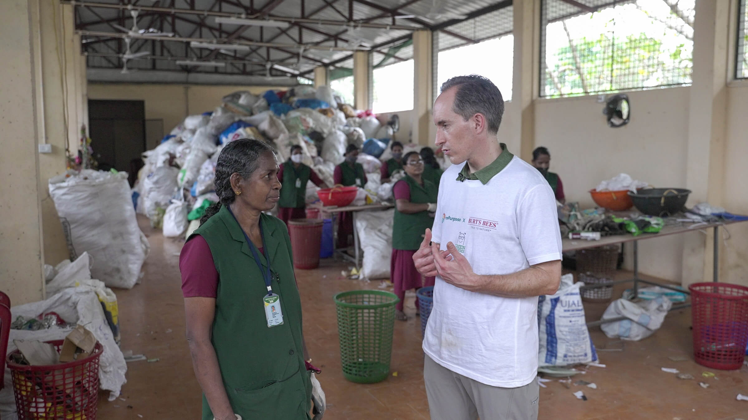 a man and woman in a room with a pile of garbage