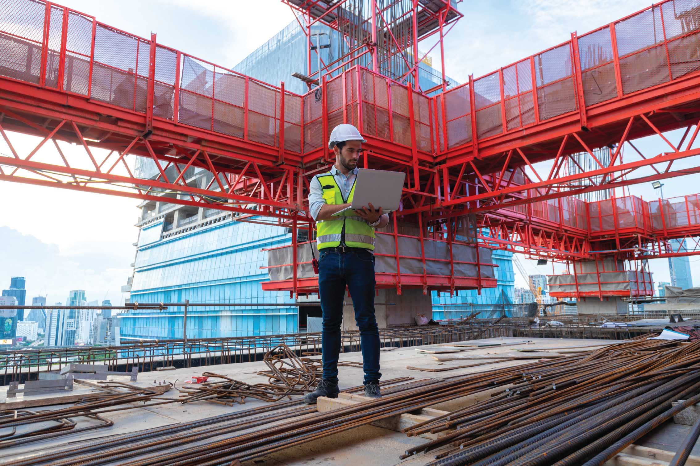 Foreman recording compliance data digitally on a construction site using a mobile device.