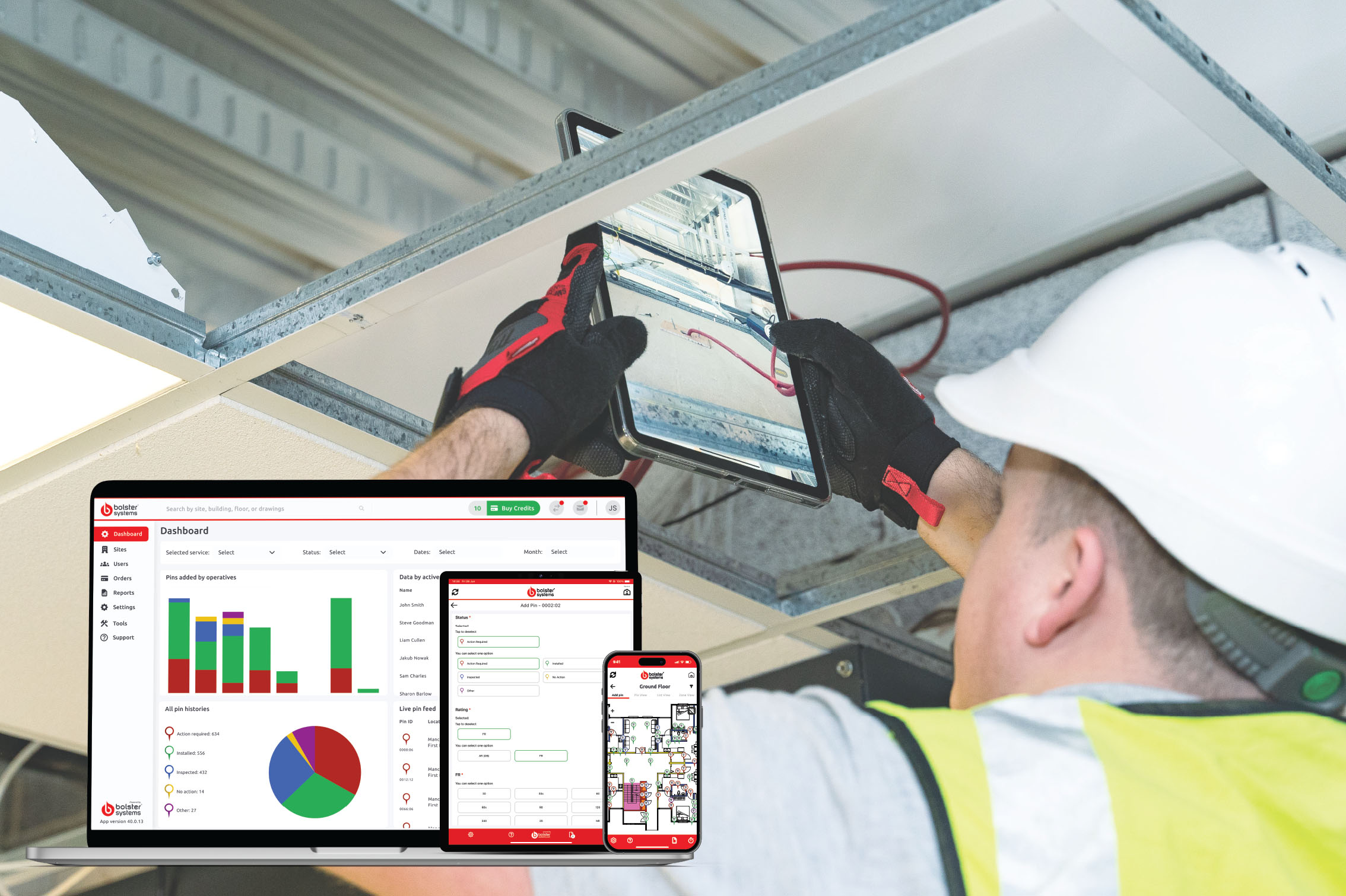 Construction worker logging a firestop installation into a mobile app, with a large project site in the background.