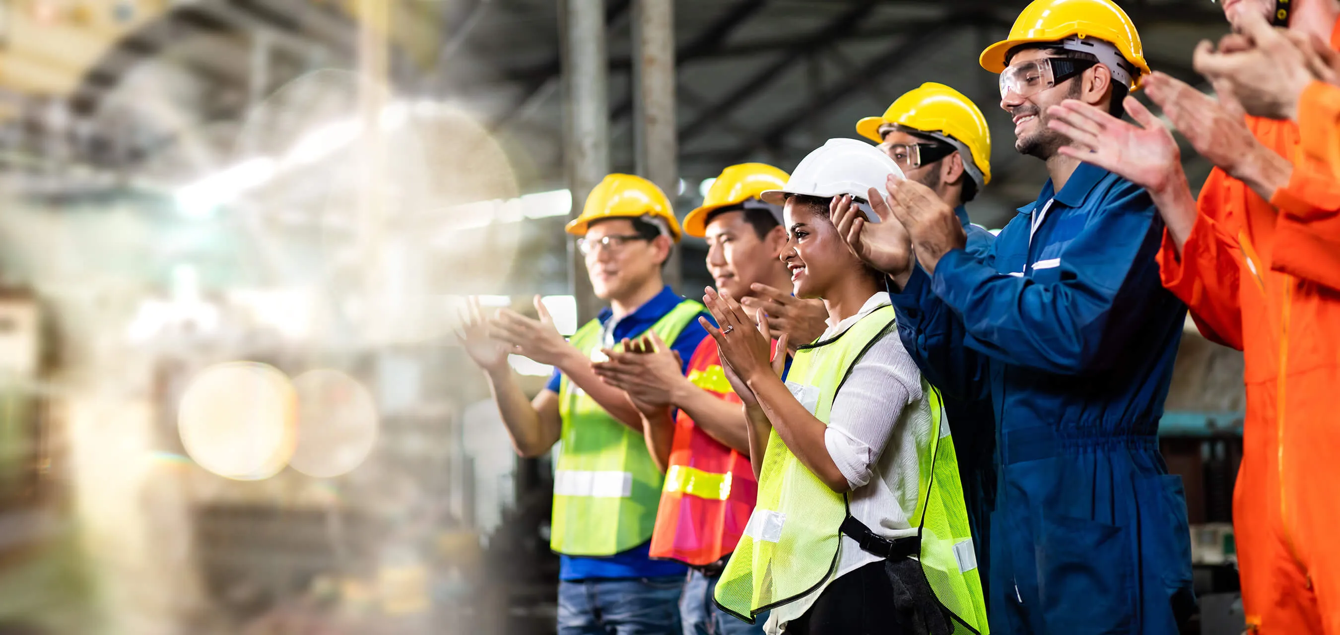 Engineering and worker team celebrate success by applauding at industrial workplace