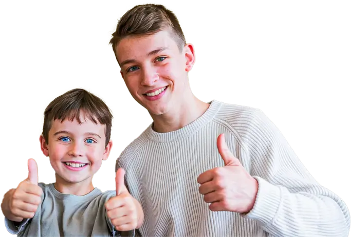 oung boy and teen with thumbs up, smiling.