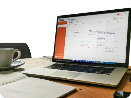 Laptop on a desk with documents, representing online learning tools and materials.