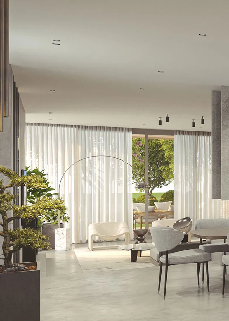 Bright living and dining area with soft gray seating, lush indoor plants, floor-to-ceiling curtains, and large sliding doors opening to a garden view.