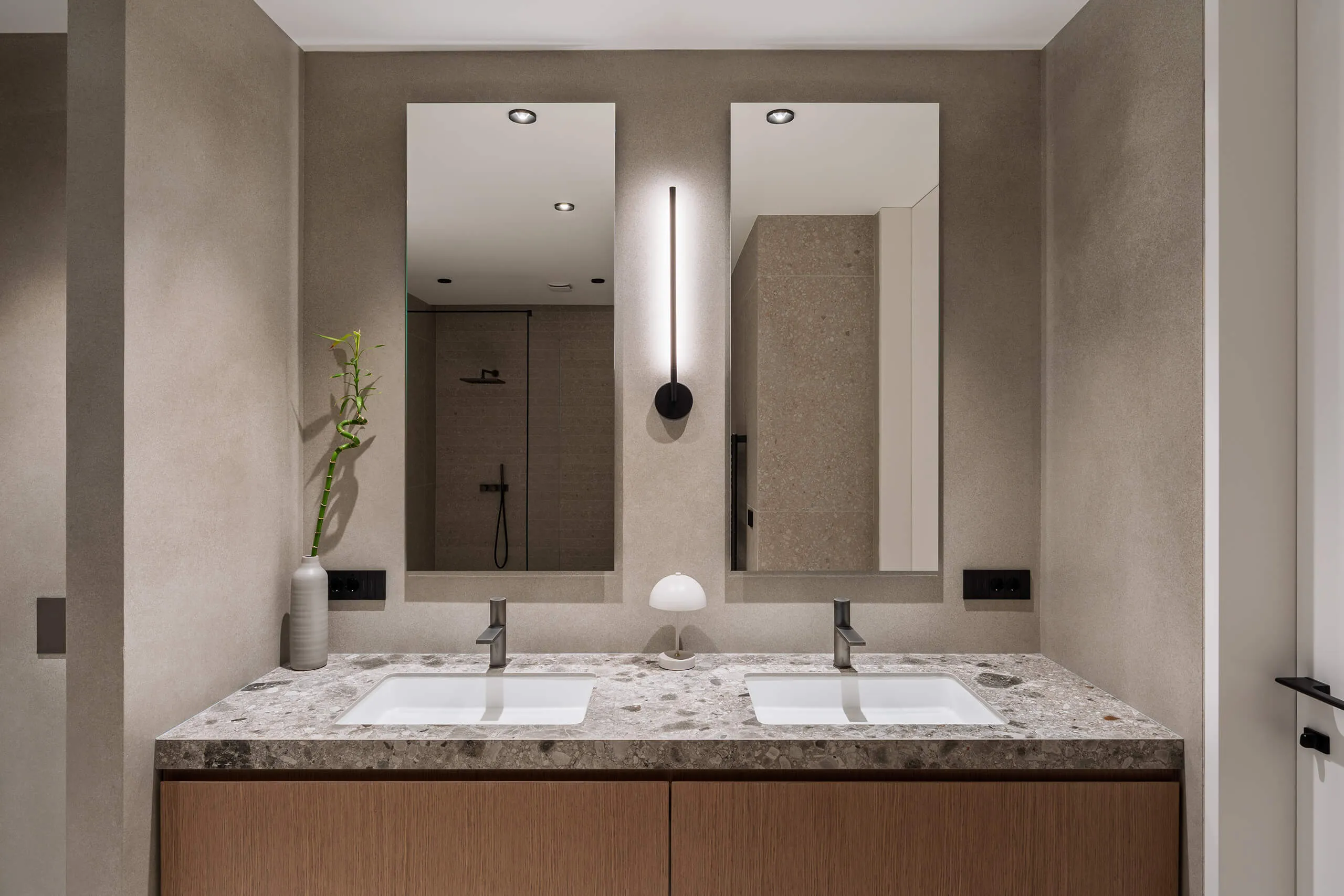 Modern rustic bedroom design in a luxury chalet by Studio Mosh, with wood-clad walls, upholstered headboard, layered bedding, and pendant lighting — elegant mountain retreat design with warm textures and soft lighting.