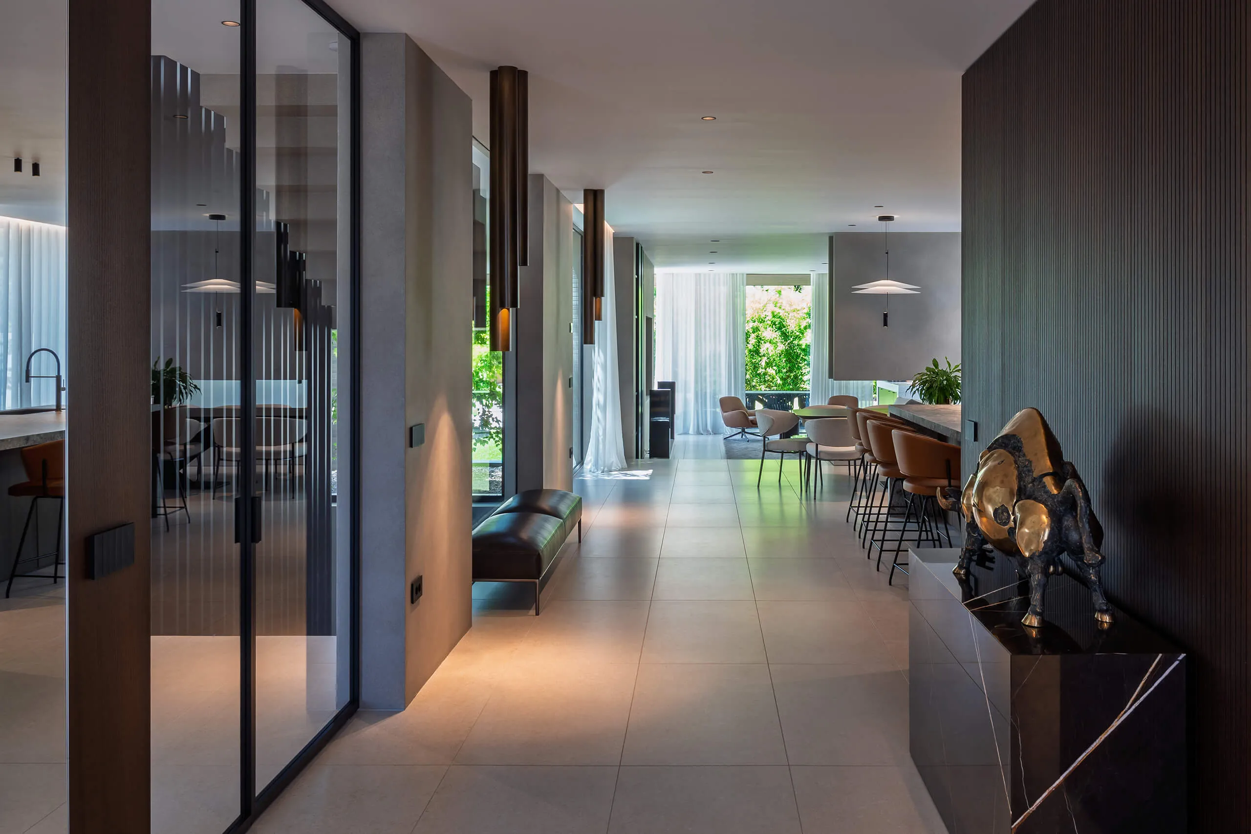 Modern rustic bedroom design in a luxury chalet by Studio Mosh, with wood-clad walls, upholstered headboard, layered bedding, and pendant lighting — elegant mountain retreat design with warm textures and soft lighting.