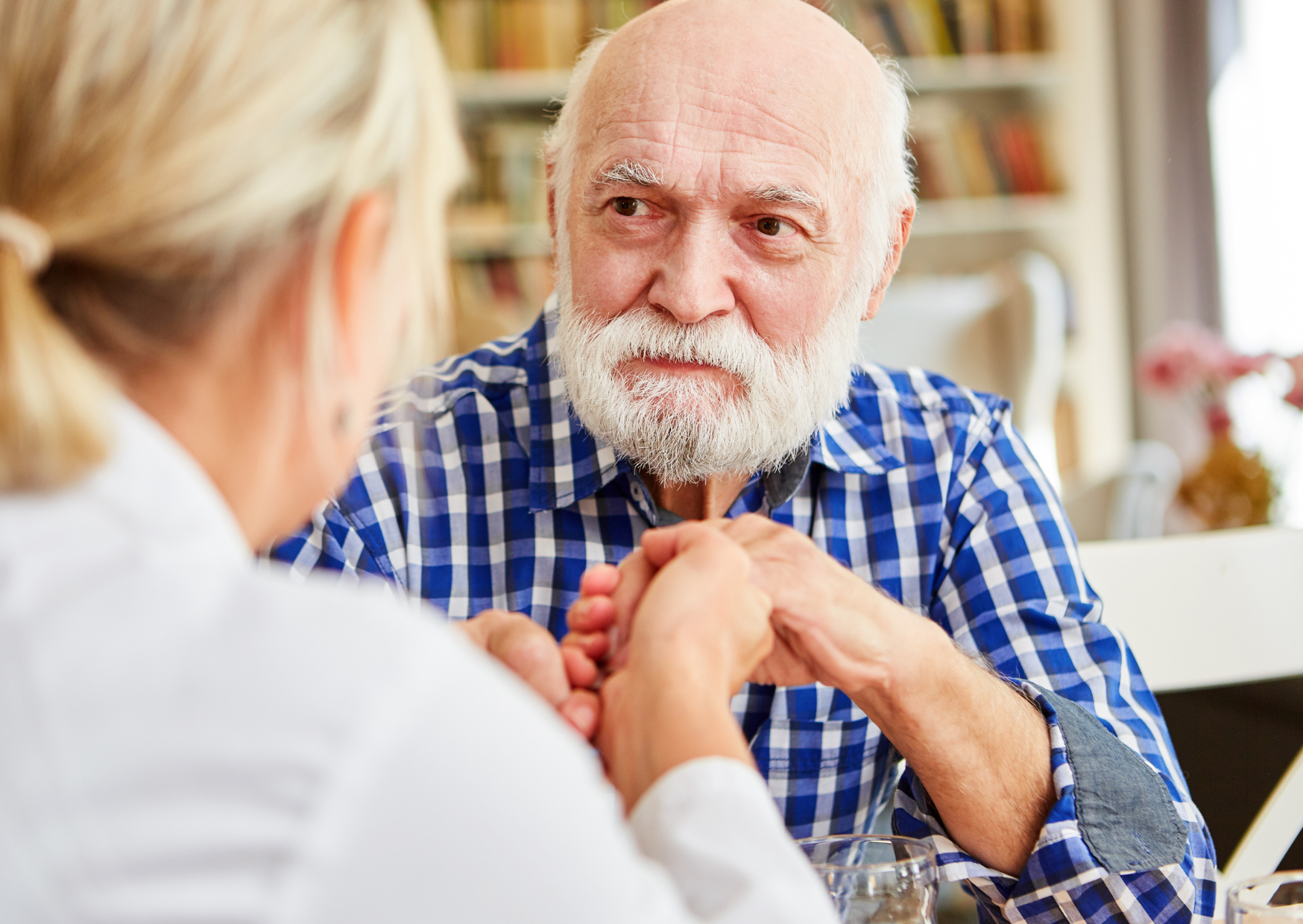 An elderly woman checking the blood pressure of her elderly husband